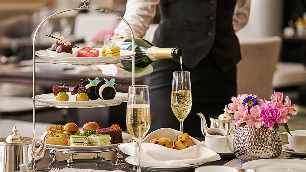 Server pouring champagne during Spring Afternoon Tea
